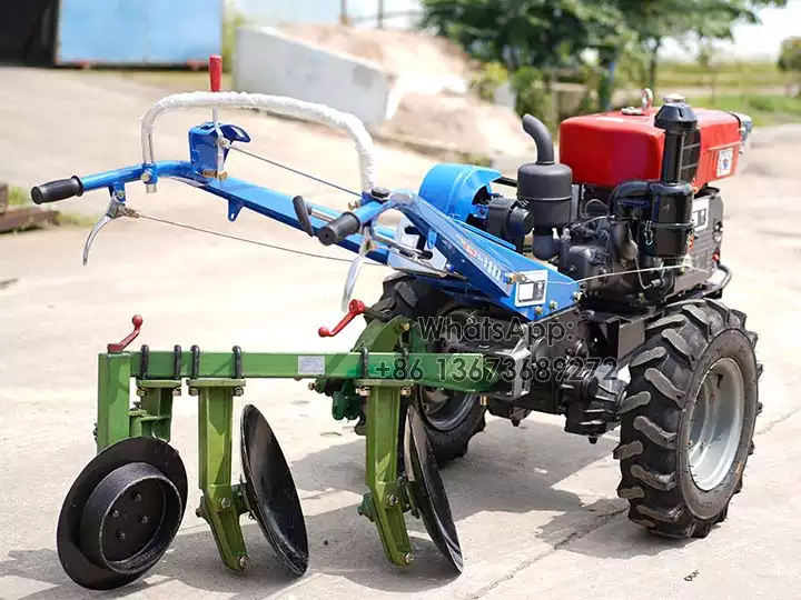 Walking behind tractor with plough